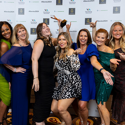 Group of people posing with an award