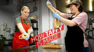 Graphic of two white women wearing cooking aprons, stretching taffy