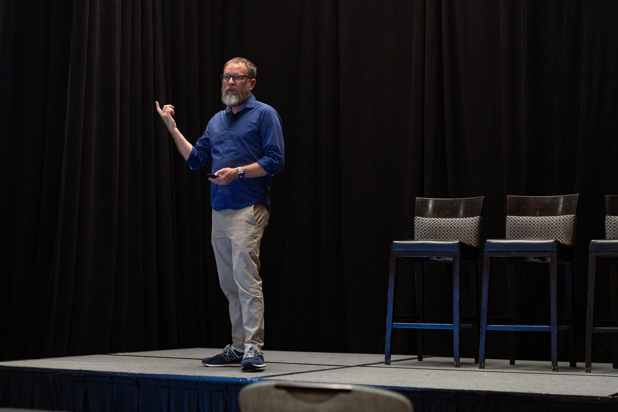 A man gestures during his presentation at DEAMcon26.